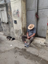 a man sleeps on the stoop in Havana, Cuba